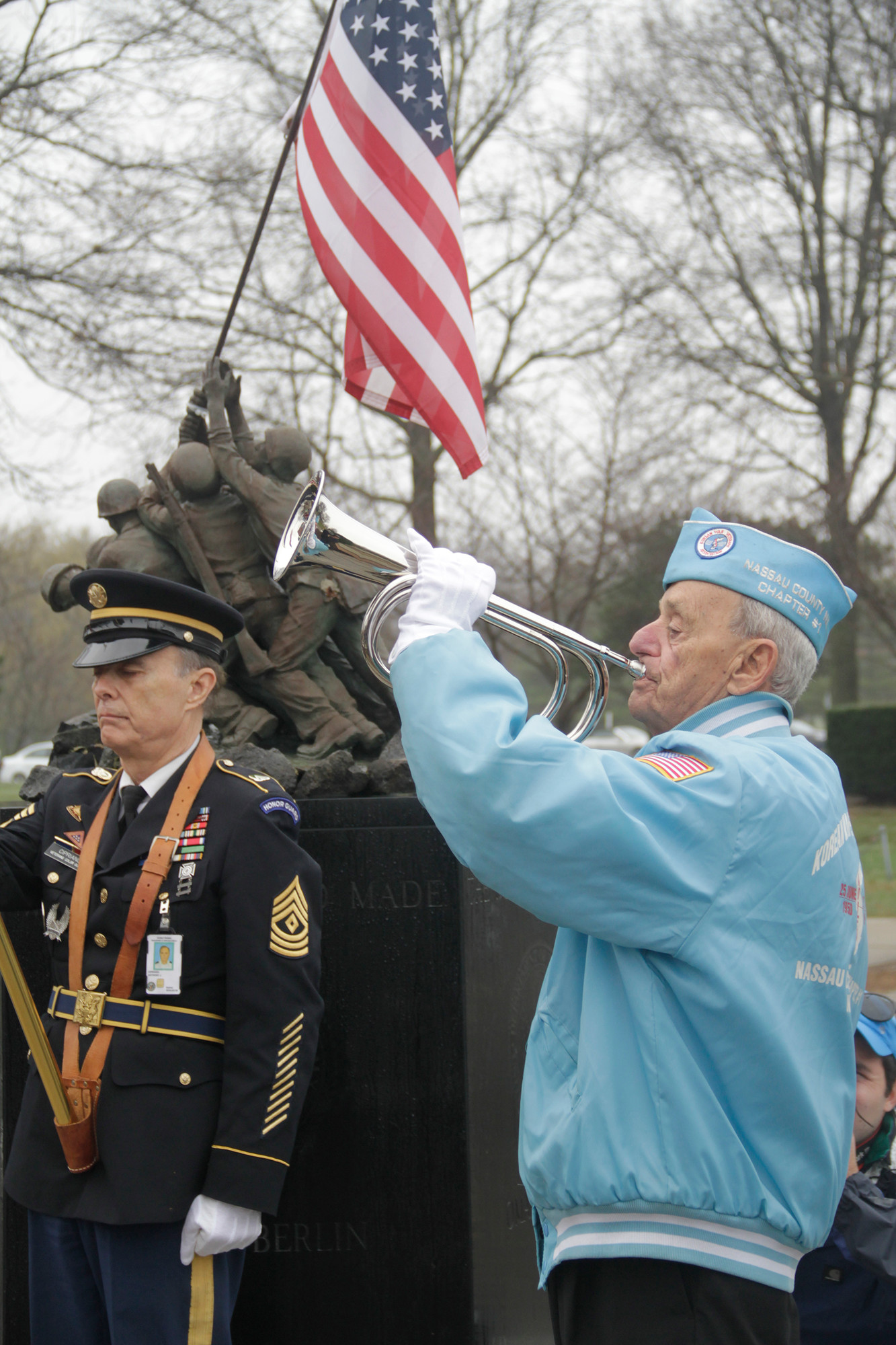 Buddy Epstein played taps while Tony Ciprian of the Veterans’ Color Guard stood at attention.