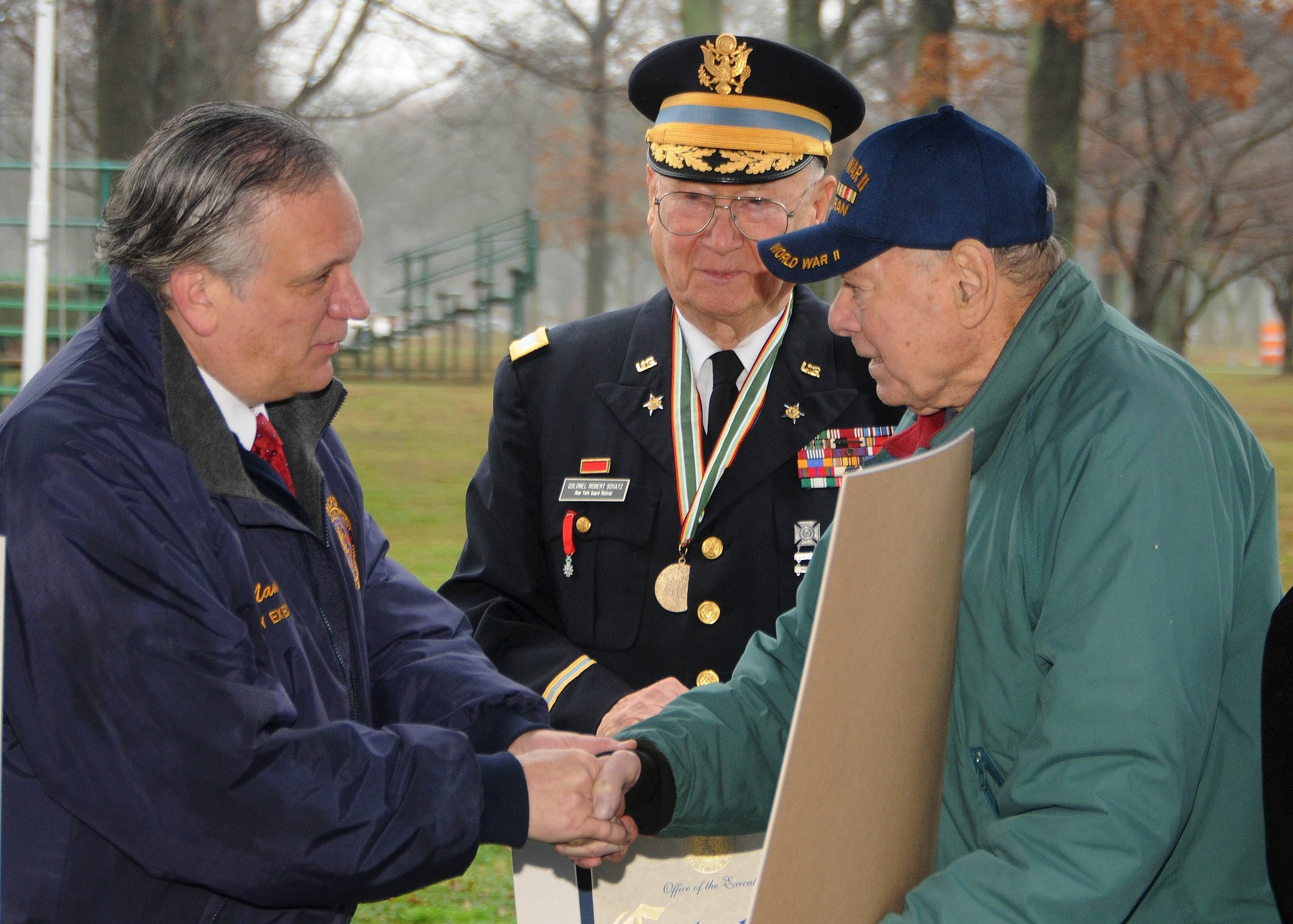 Nassau County Executive Ed Mangano presented Felix Iannacone, a 91-year-old East Meadowite and Battle of the Bulge veteran, with a citation at the ceremony while Robert Scatz looked on.