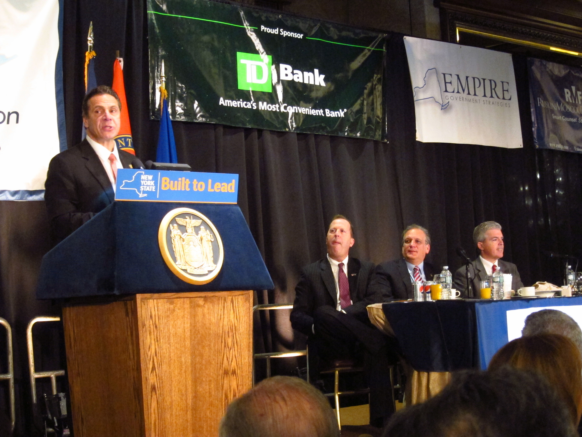 Gov. Andrew Cuomo outlined plans for 2016, as Long Island Association president Kevin Law, left, Nassau County Executive Ed Mangano, center, and Suffolk County Executive Steve Bellone listened.
