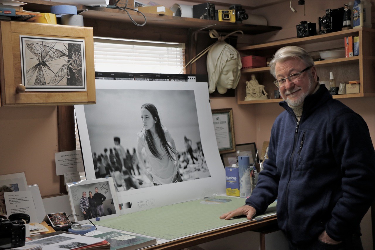 Photographer Joseph Szabo stood next to a copy of his iconic work, “Priscilla” during a Herald visit to his studio last week.
