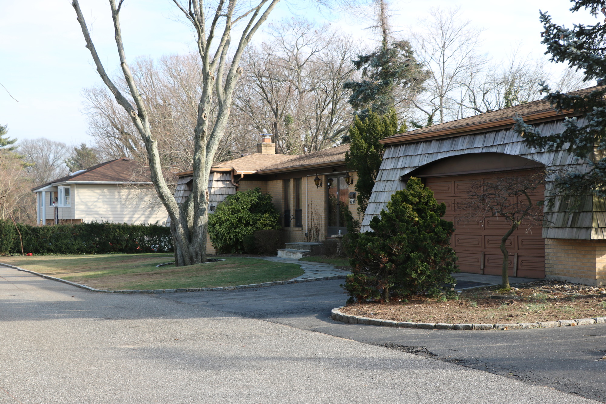 A company seeks to place 12 condominiums on land currently occupied by these two homes on Hempstead Avenue in Malverne Oaks, which is outside the village’s borders.