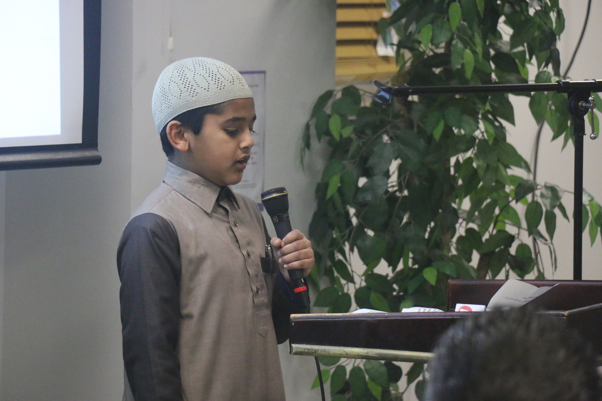 Zaid Kapadia, 12, at left, recited a verse from the Quran.