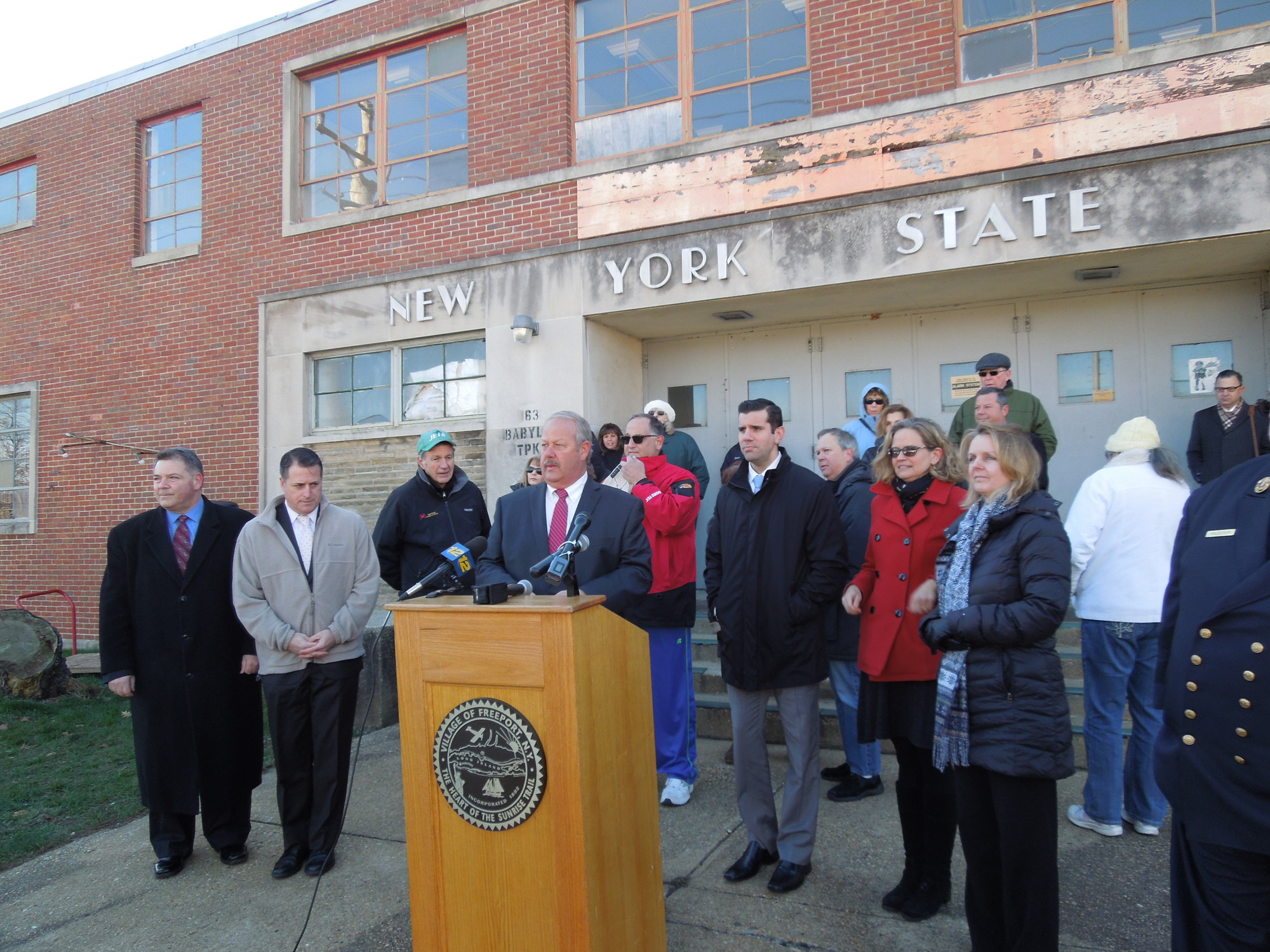 Mayor Robert Kennedy, at lectern, was joined by local and state officials on Jan. 11 to urge the governor to transfer the armory to the village for use by the Department of Public Works