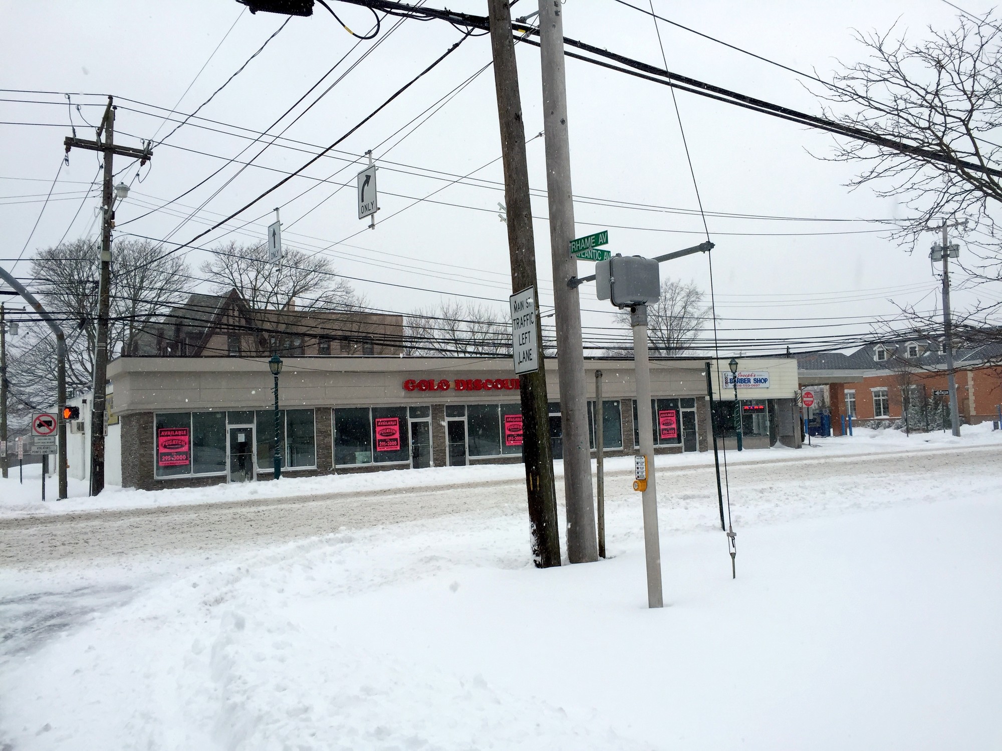 Main Street in East Rockaway was deserted at 10 a.m. as the snow blew.