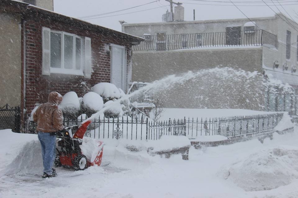 A man on Hempstead Turnpike in Franklin Square clears a path in front of his house.