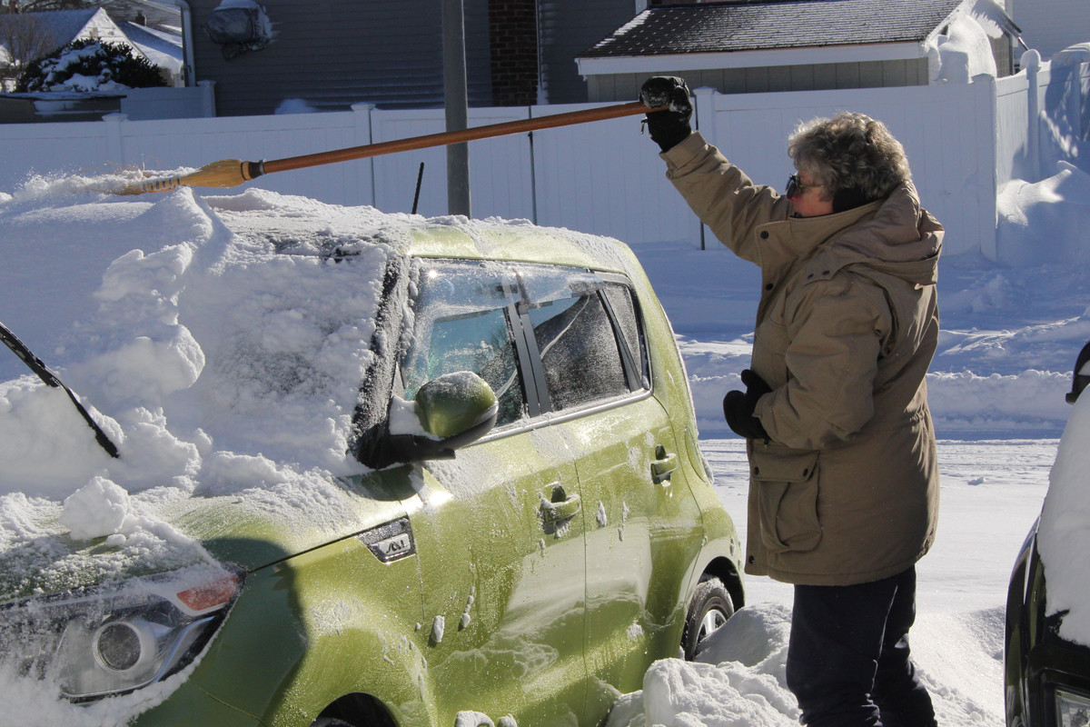 Audrey Healy, of Seaford, cleaned off her car Sunday morning.