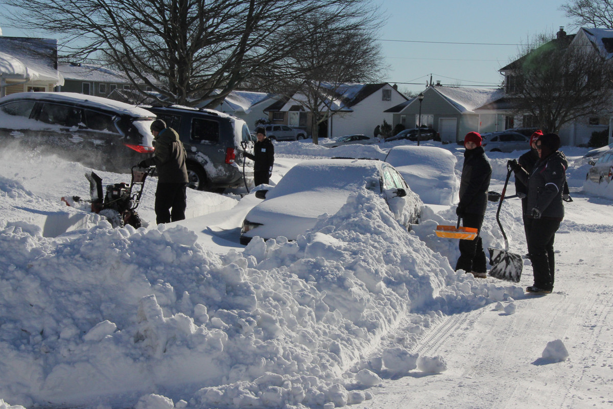 The Piccone and Karounos Families worked together to clear snow Sunday,