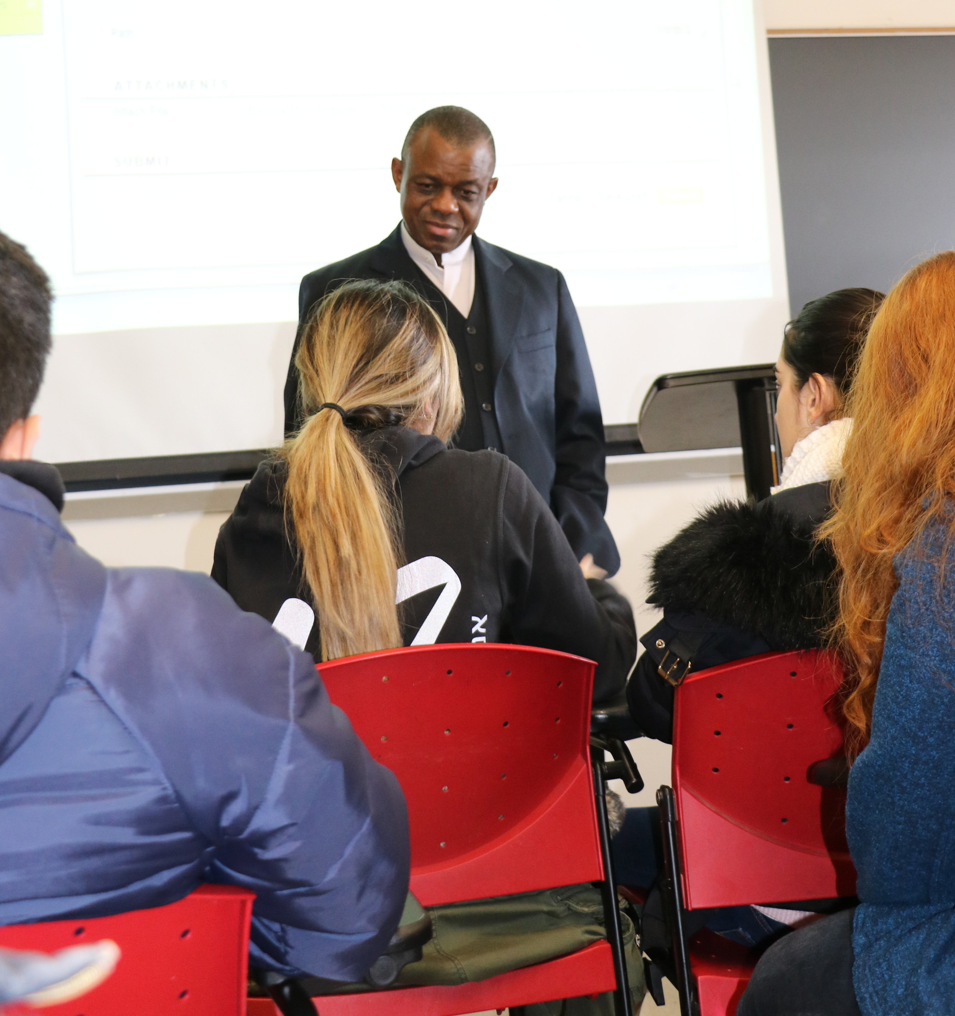The Rev. Chux Okochi answered questions from his pharmacy students at St. John’s University last week. Okochi has been teaching at the university since 2003.