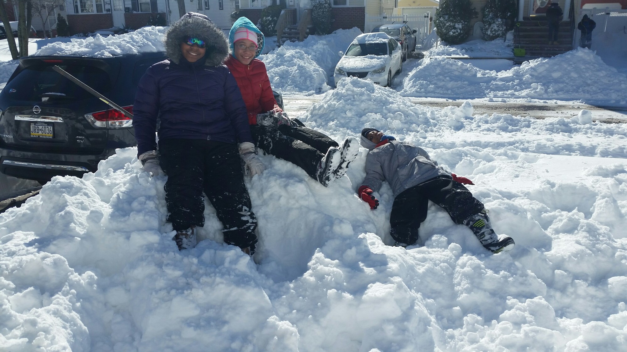 The mounds of snow created by digging out on Sunday made for some good climbing, as Amiya, 12, Rasheedah, 13, and Jaylen, 6, found out.