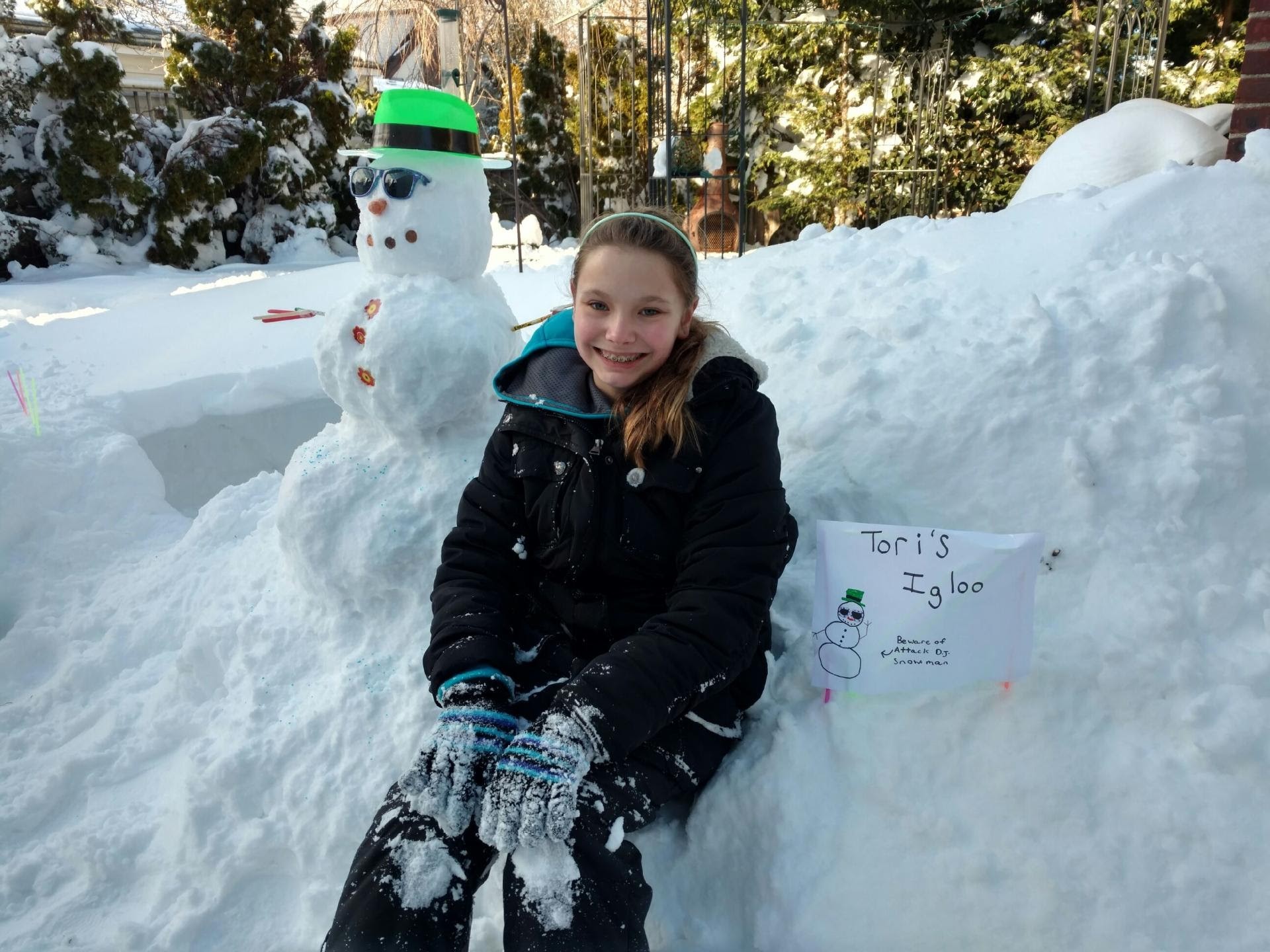 Victoria Andreo, 10, set up a   snowman DJ outside an igloo she    created in her family’s yard.
