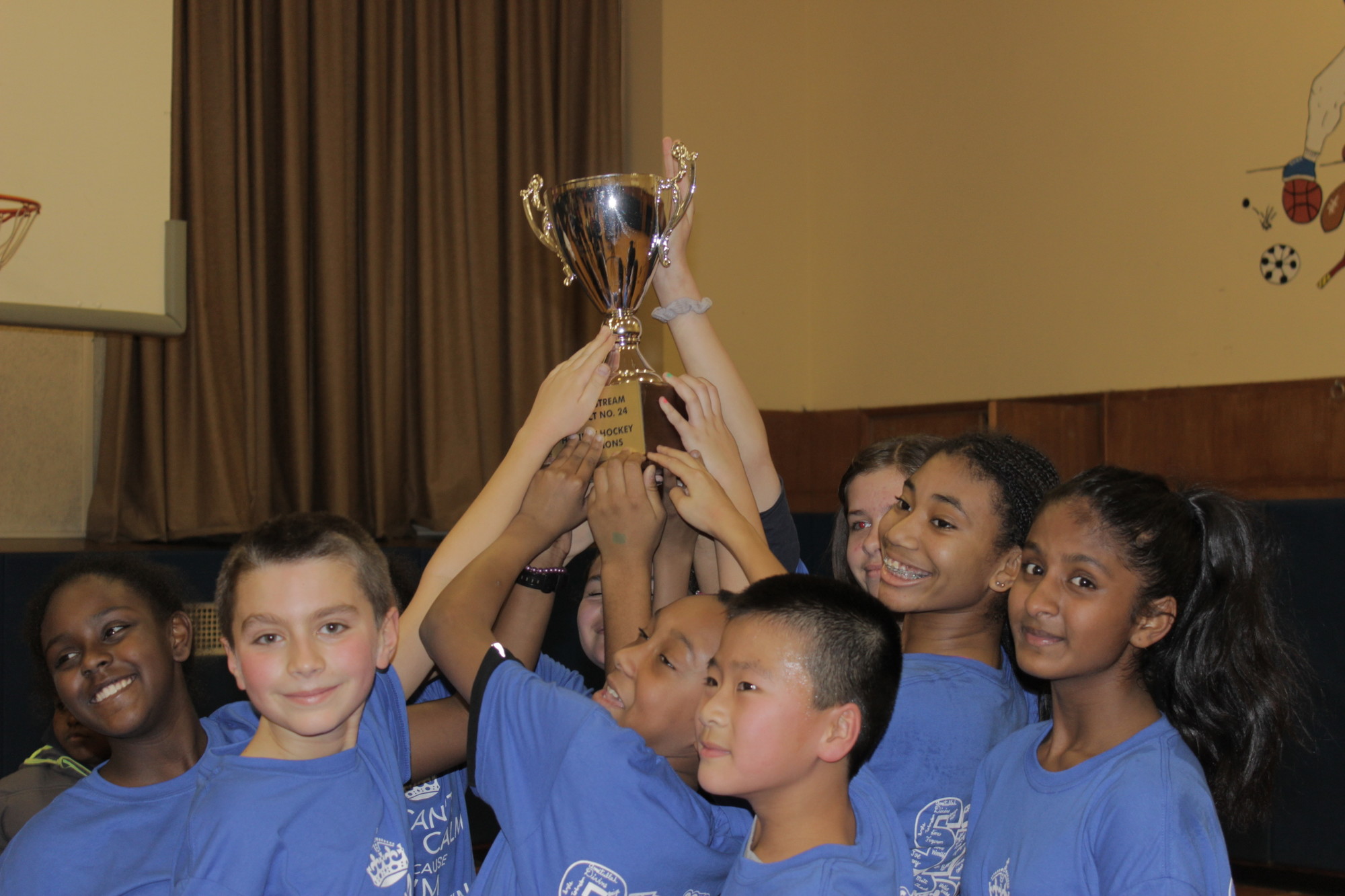 Players on Brooklyn Avenue Team No. 1 celebrated their win by holding up the victory cup.