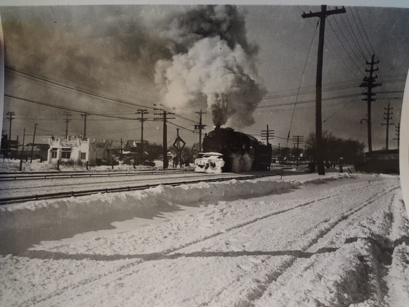 A steam engine barreled through the snow in this photo taken sometime before 1939, before the LIRR tracks were elevated.