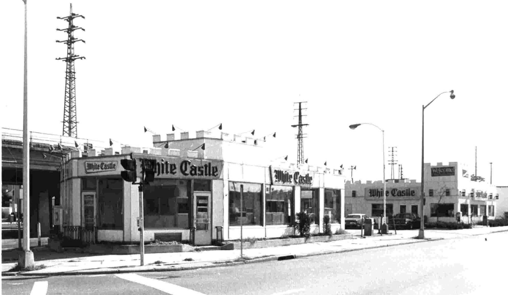 The ‘Two White Castles’ was taken by Lynbrook photographer John Cribbin, probably in the late sixties or early seventies. It depicts the old structure in the foreground being replaced by the new one to the rear (right) of the photo.