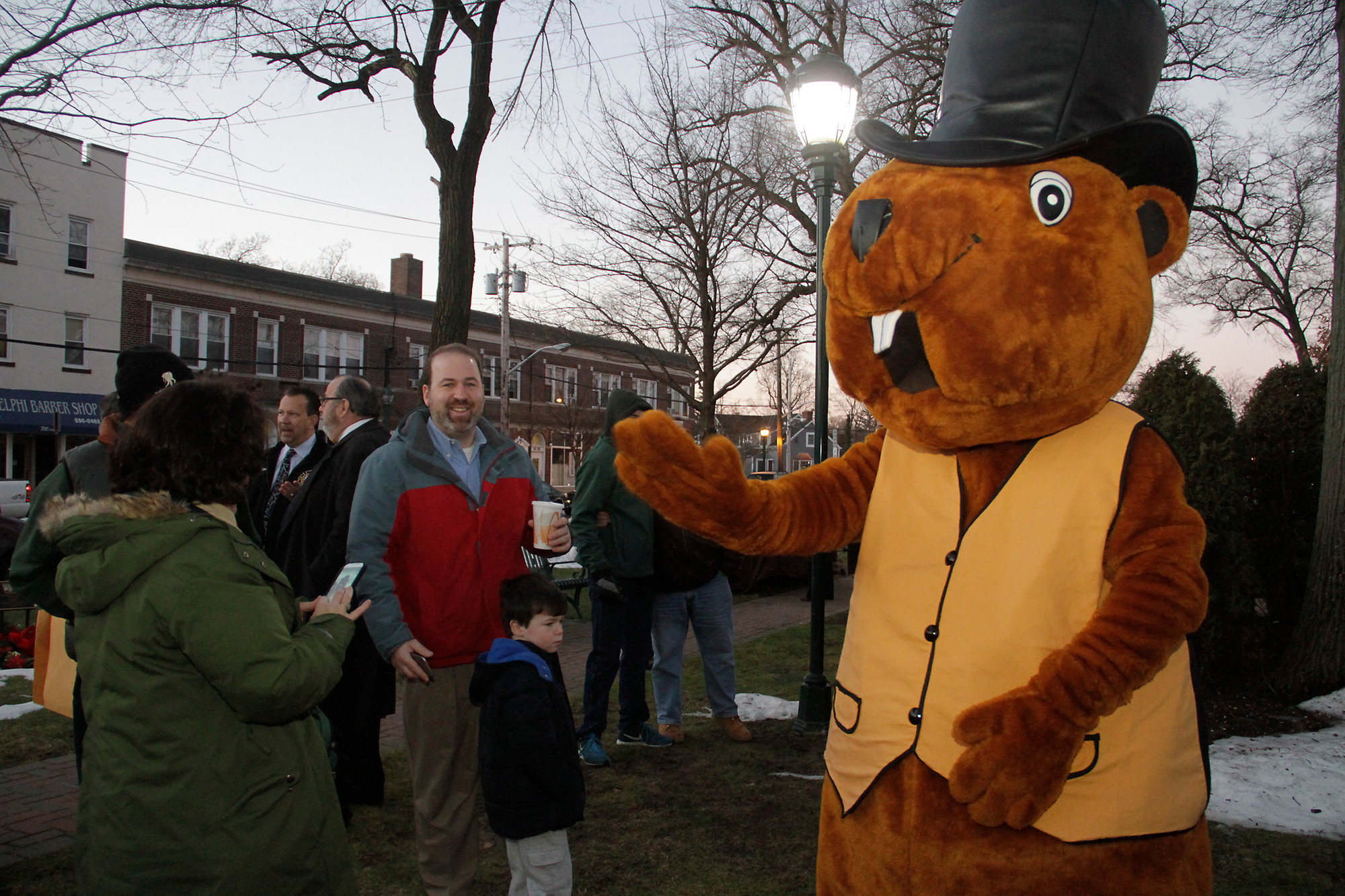 Peter Robideau, in a larger-than-life groundhog costume, waves to the crowd.