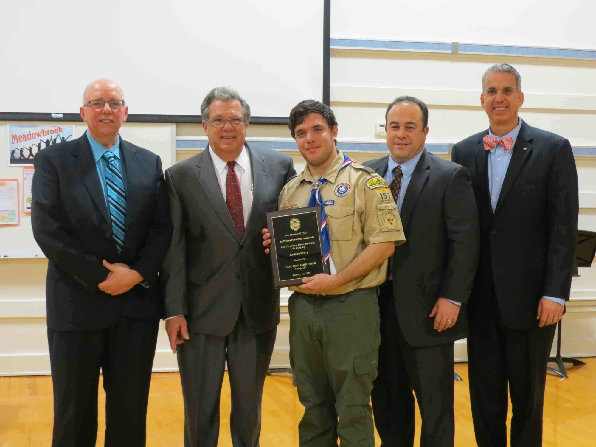 During the East Meadow School District’s Jan. 14 Board of Education meeting, President Joseph Parisi, left, Superintendent Leon Campo, East Meadow High School Principal Richard Howard and Board of Education Trustee Jeffrey Rosenking honored Clay Benjamin Fried (center) for achieving Eagle Scout ranking in Troop 157.