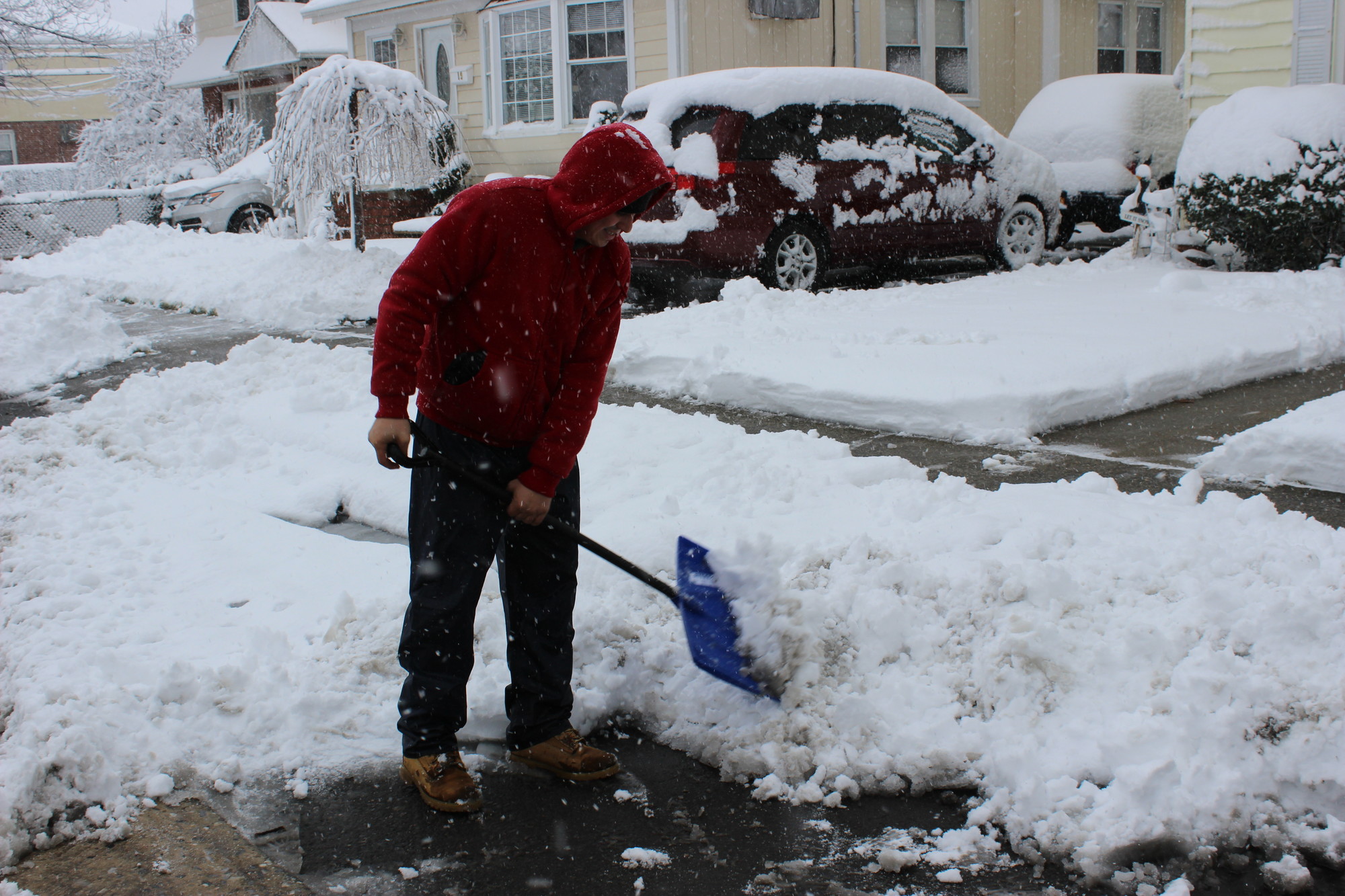 Mario Castro shoveled outside his home on Cottage Street Friday afternoon.