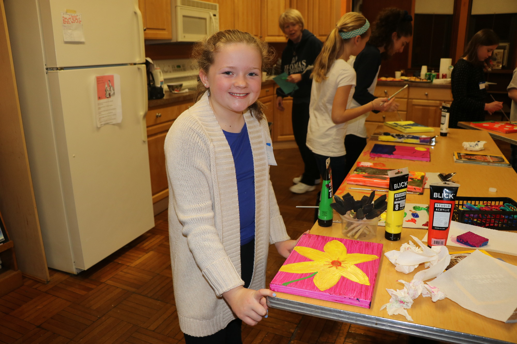 Ella, a fifth-grader at St. Thomas, said Young had inspired her to paint a sunflower.