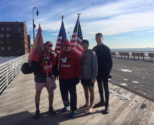 Runners participating in the “Hot Chocolate Run” carry American flags along the Long Beach boardwalk on Jan. 30.