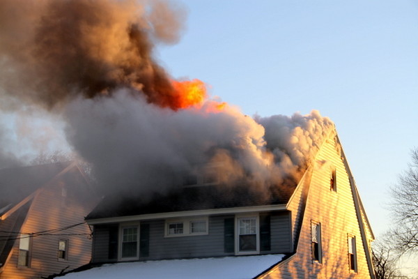 Firefighters battle the blaze in the wind and cold on Sunday afternoon.