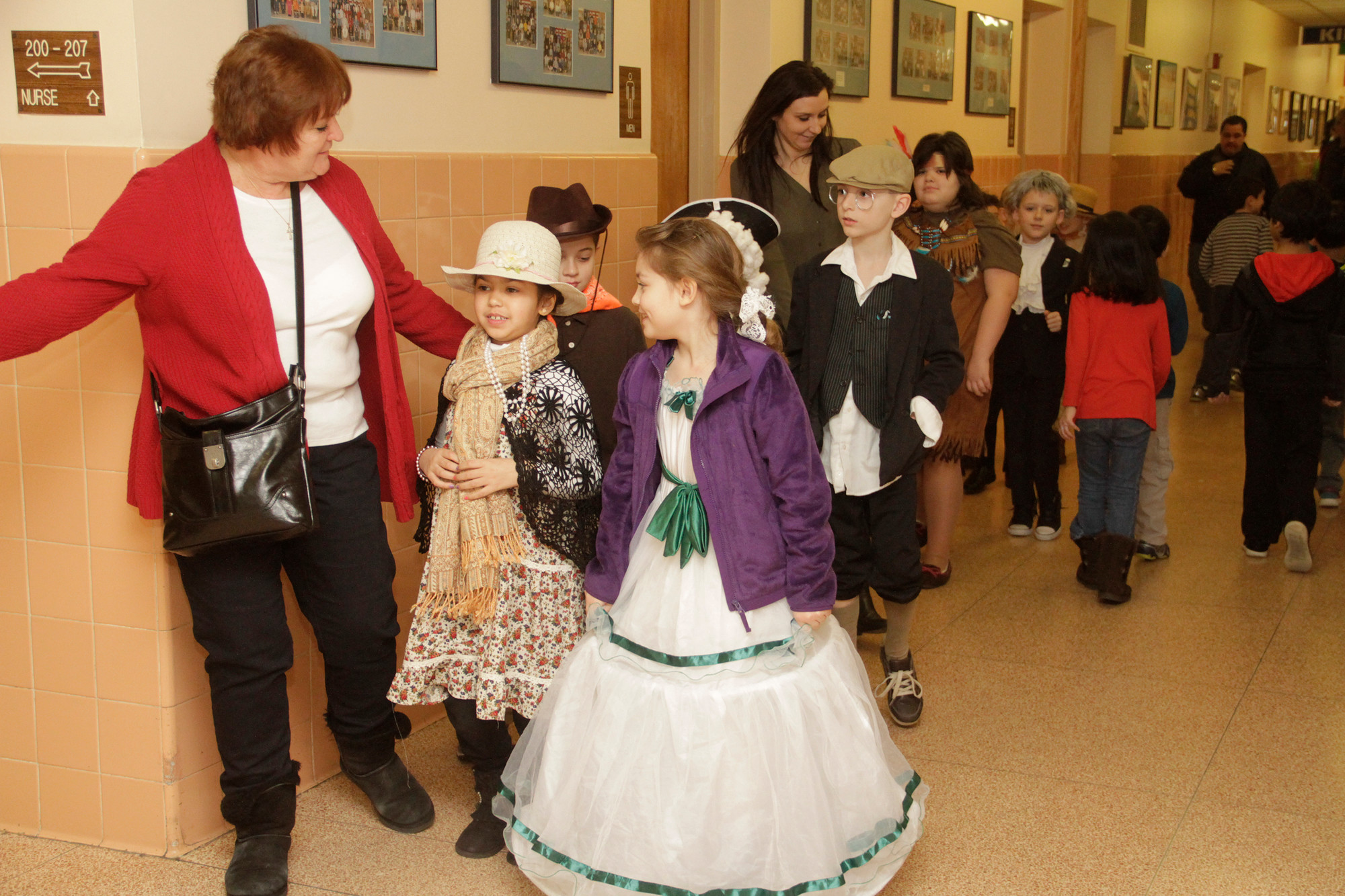 The children dressed like different historical figures, showing off their costumes while walking through the halls.