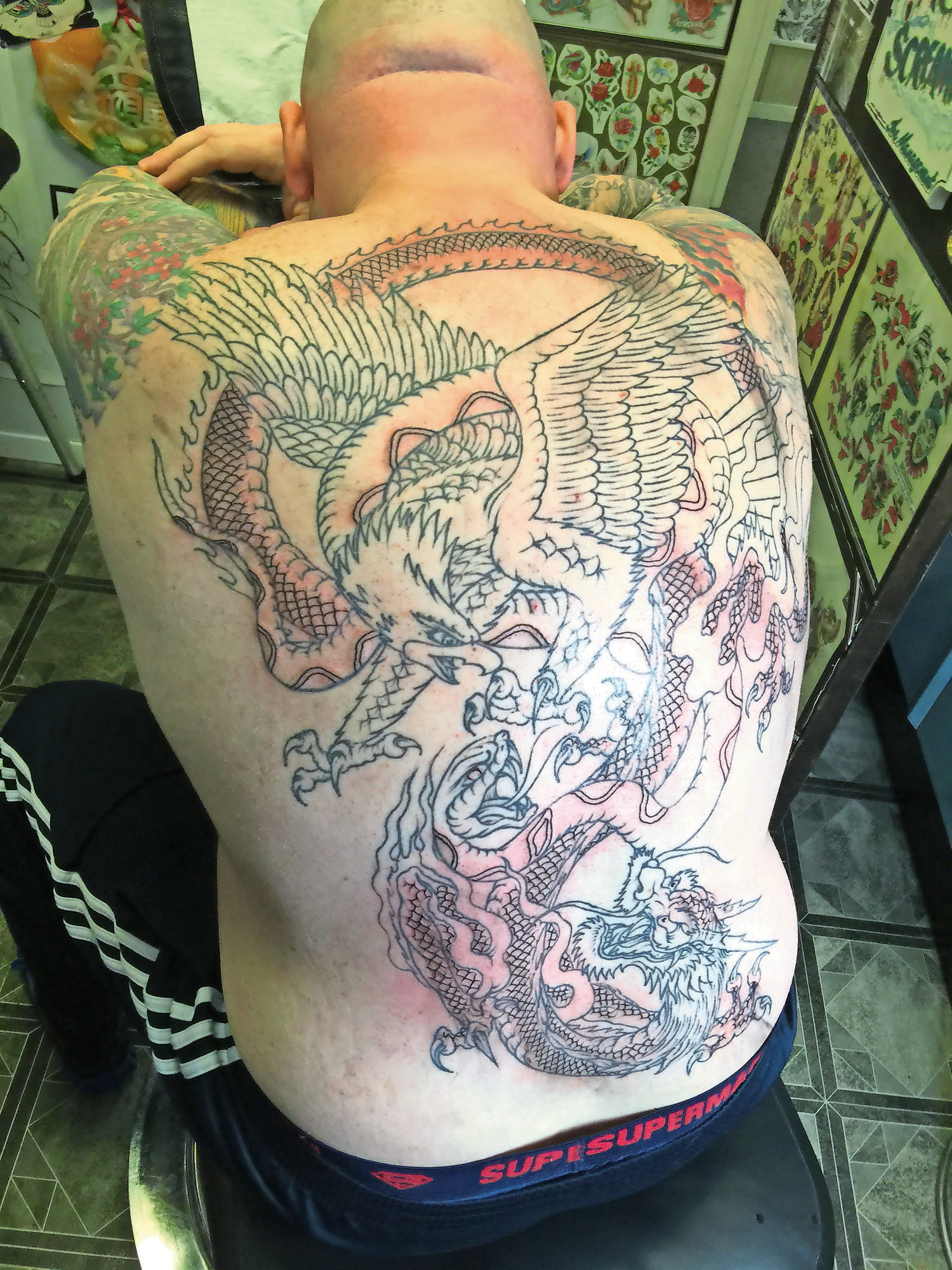 Eric Voye got a tattoo of an eagle battling a dragon last week. Montgomery inked the rest of the tattoo on Friday. Voye will go back one last time for coloring.