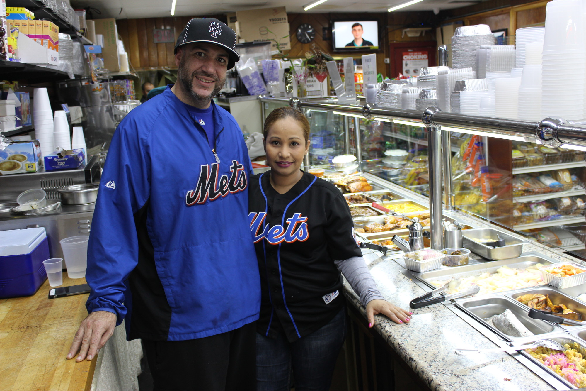 Jovanny Quiroz, left, owner of Papo Deli on Rockaway Avenue, and his wife, Estrella Agramonte, each cook some of the deli’s authentic Dominican dishes.