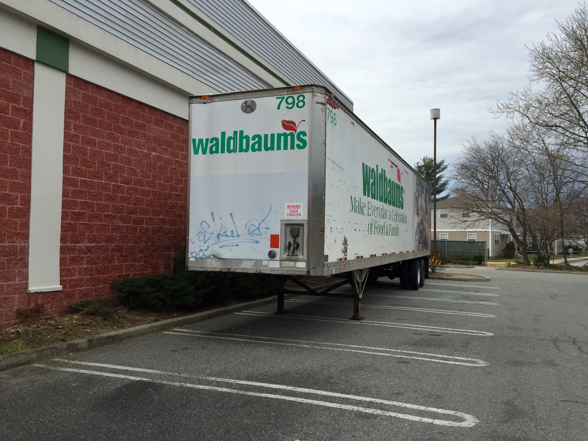 Community members pointed out that a Waldbaum’s trailer, marked with graffiti, sitting on the side of the building.