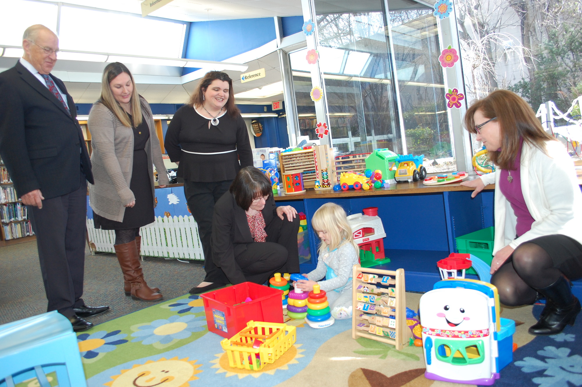 Assemblyman David McDonough, far left, Family Place librarians Michelle Kenney and Kristen Todd-Wurm, Wantagh Library Director Maggie Marino and children’s librarian Susan Finck watched 4-year-old Arianna Grout play with some of the new toys.