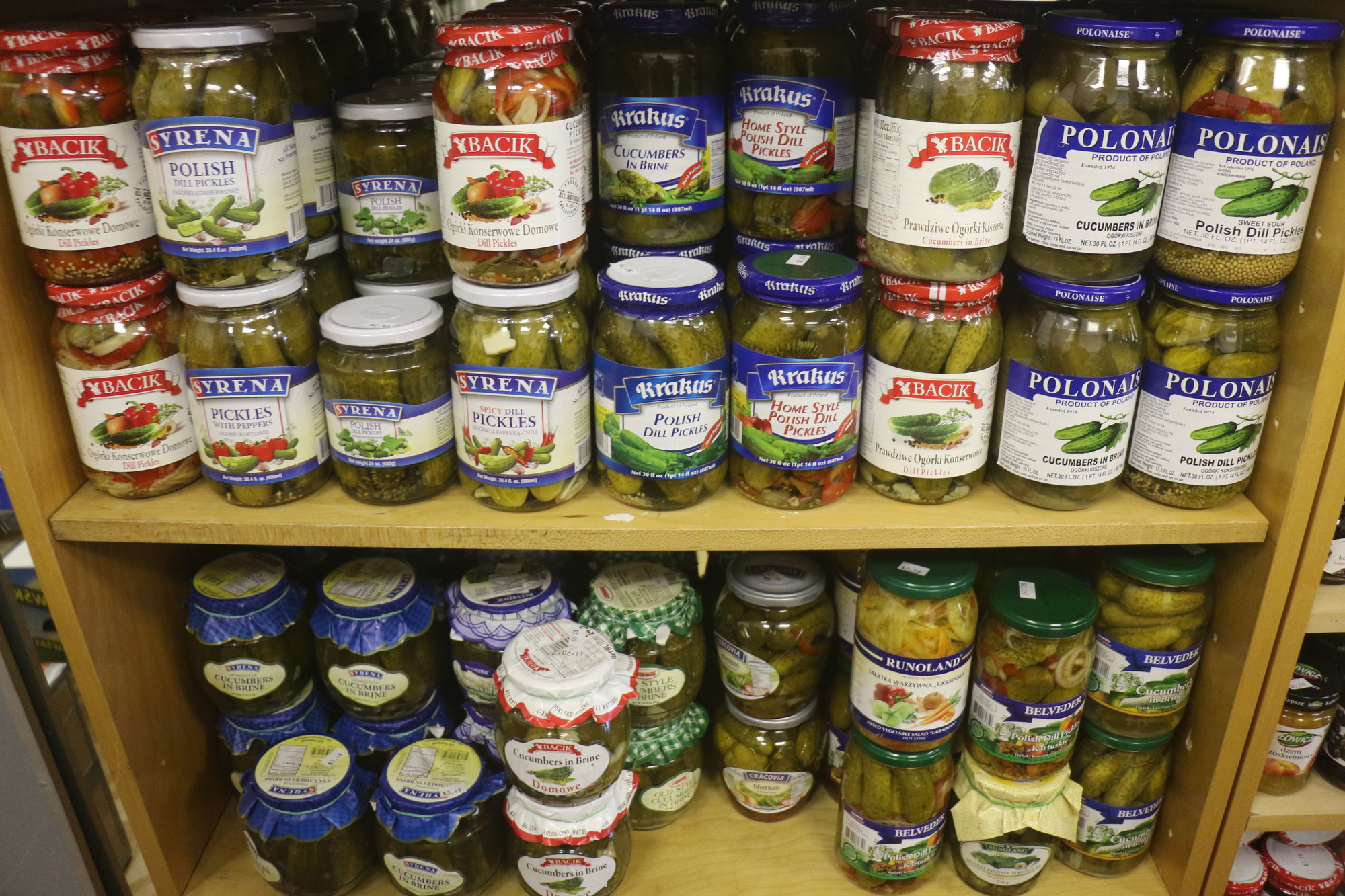 Assorted pickles fill the shelves at the back of the store.