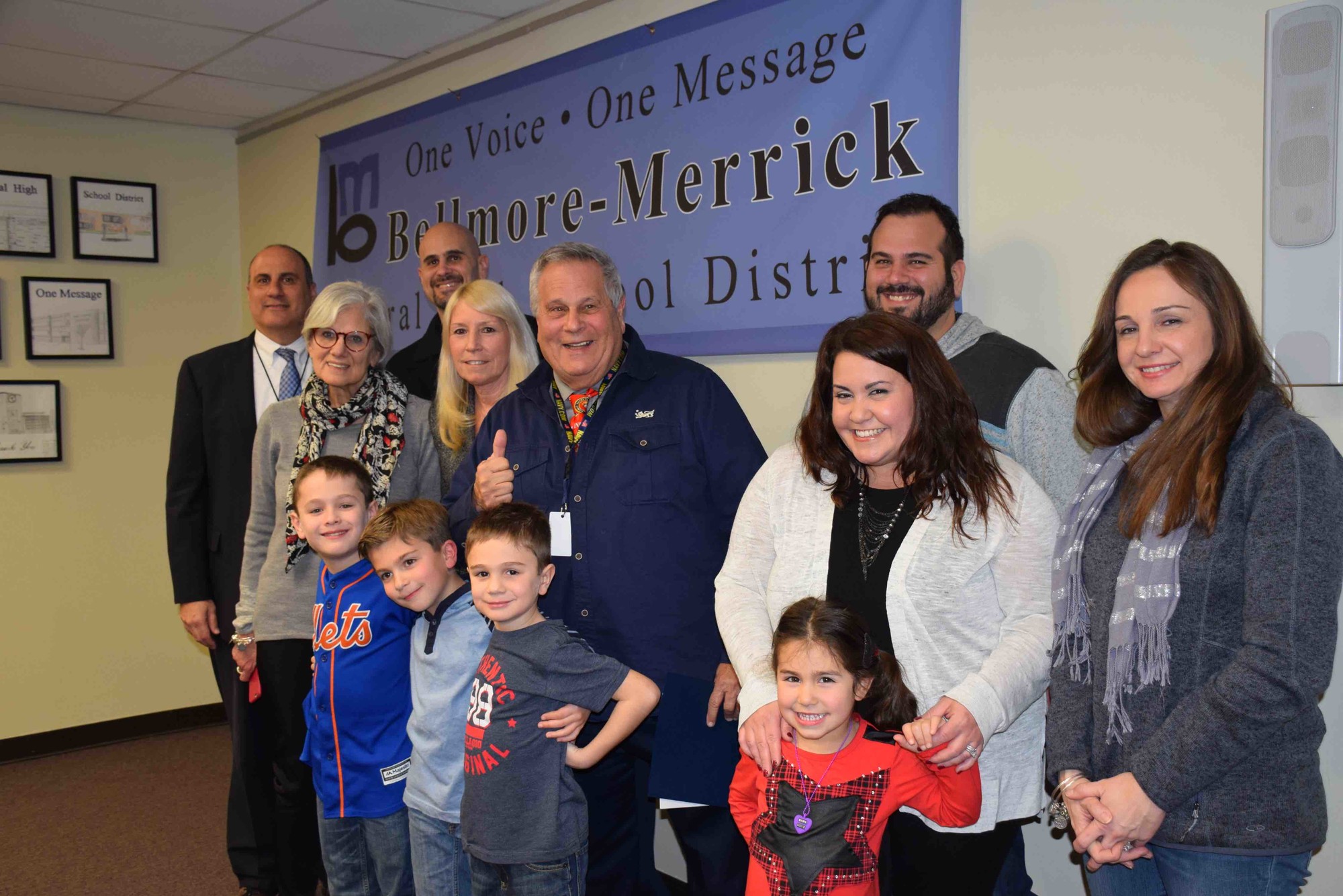 Steve Rose, center, founder of the Bellmore-Merrick Family Project, was honored at the March 2 Central District Board of Education meeting. Joining him were, at left, John DeTommaso, the Central District superintendent, Janet Goller, the Board of Education vice president, to Rose’s immediate left, and his family.