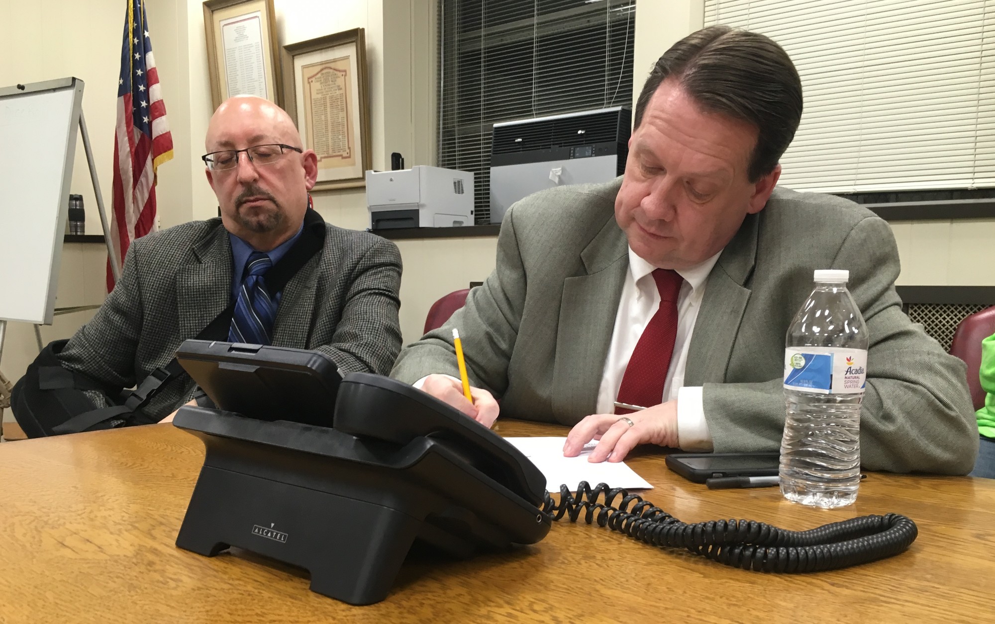 Paul Lynch, right, Lynbrook’s school district assistant superintendent for finance, operations and information systems, waited for the results on Tuesday night. With him was Joseph Pallotta, director of fine and performing arts for the district.