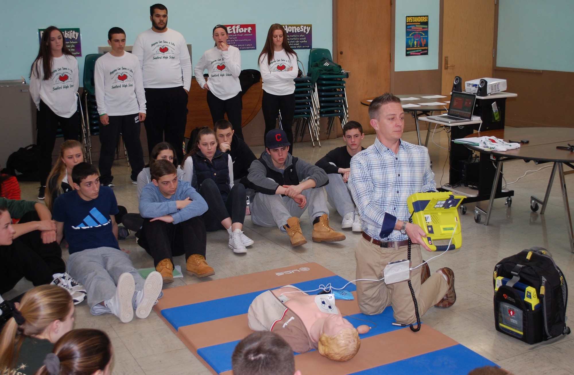 Seaford athletic trainer Michael Spreckels taught high school athletes how to use a portable automated external defibrillator at a training session on March 3.