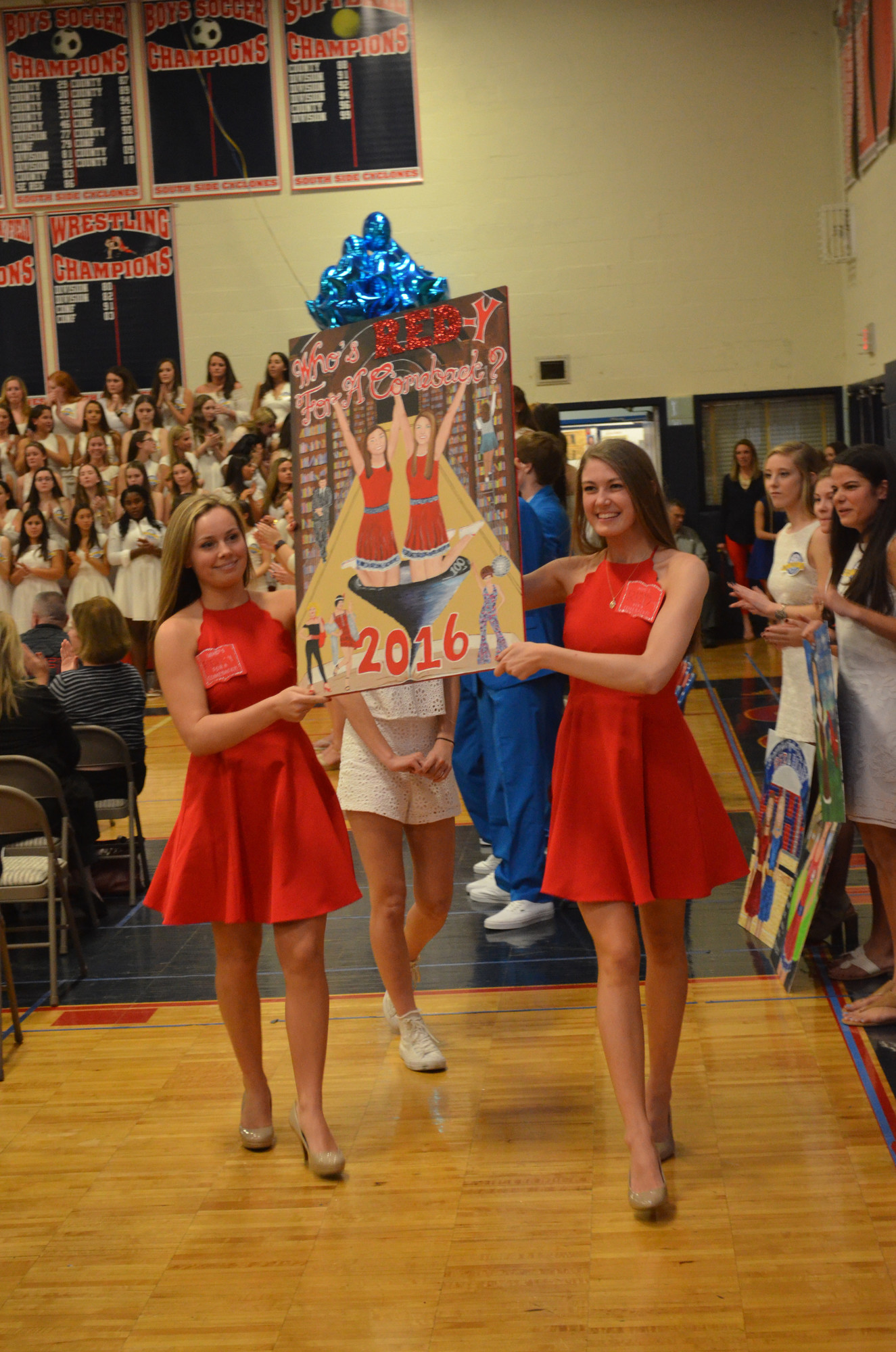 Red Captains Kelsey Schuermann, left, and Haley McDonald showed of the Red Team’s emblem, which was judged to be the best.