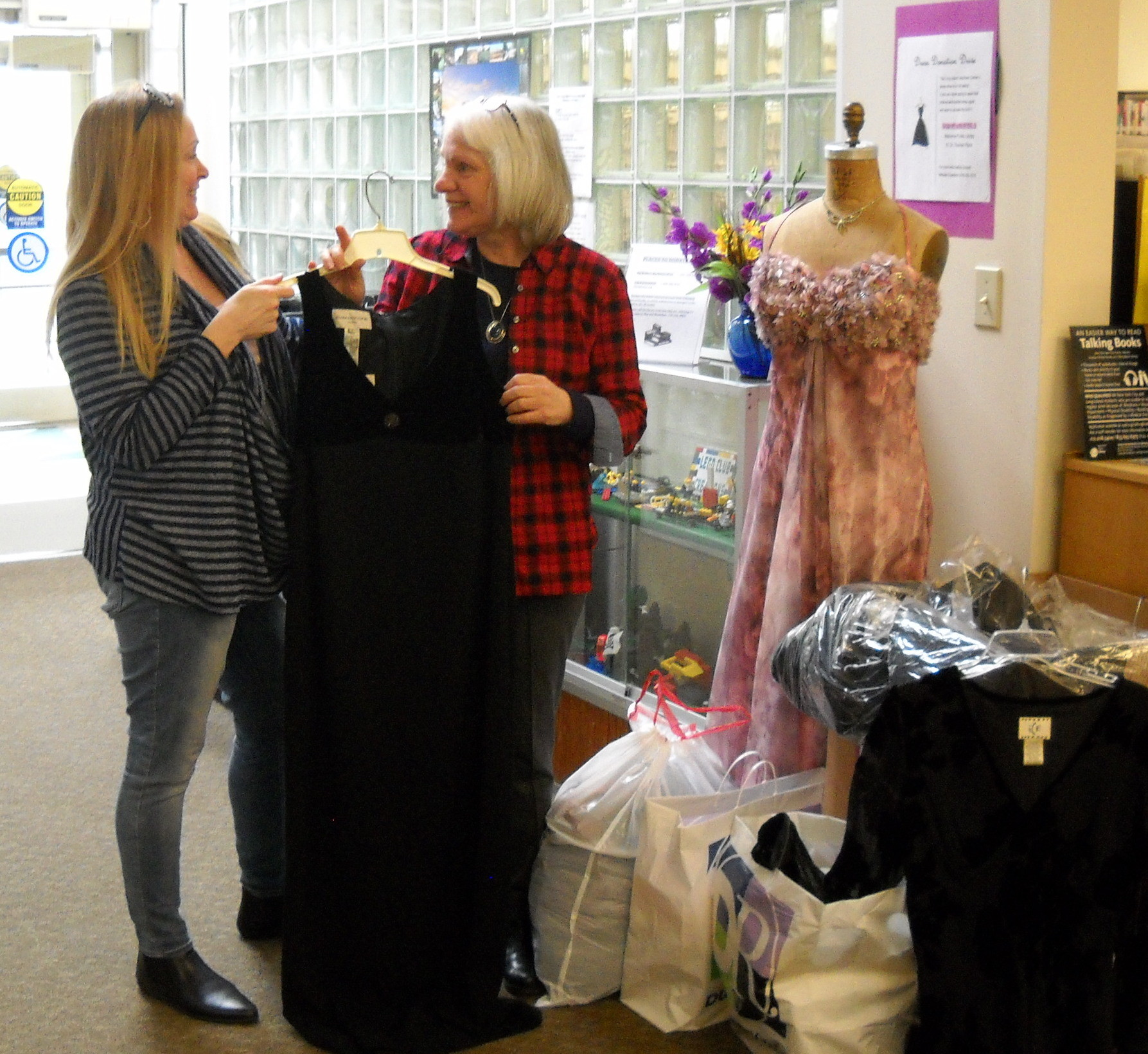The Malverne Library is an official drop-off site for the Long Island Volunteer Center’s Prom Boutique, an island-wide effort to provide prom dresses to economically disadvantaged girls. Here, volunteer Michele Esselborn, left, gathers donations left at the library with Malverne librarian, Cathy Wellikoff.