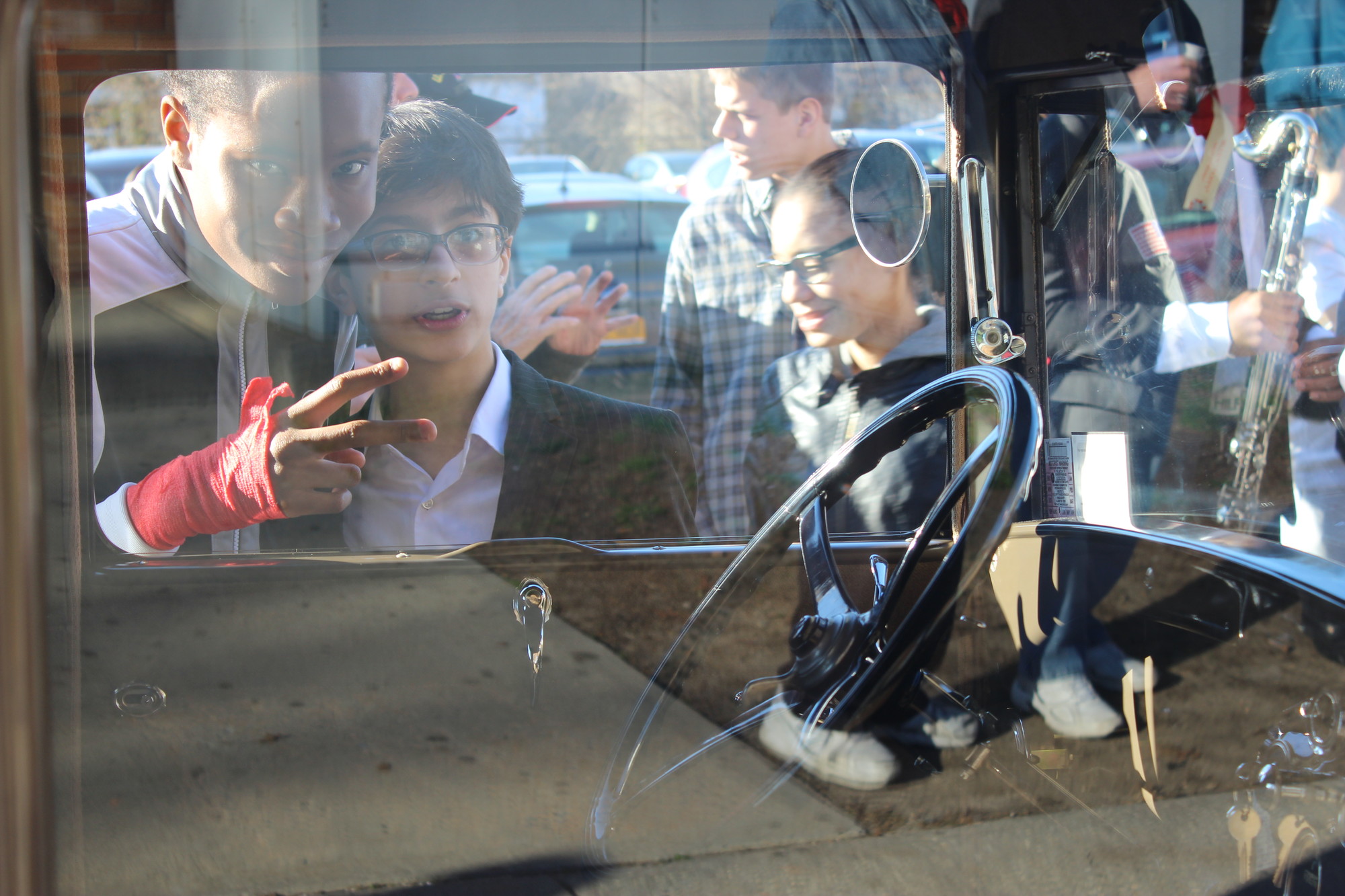 Students peered into the cars and learned about some of the distinguishing characteristics of early automobiles.