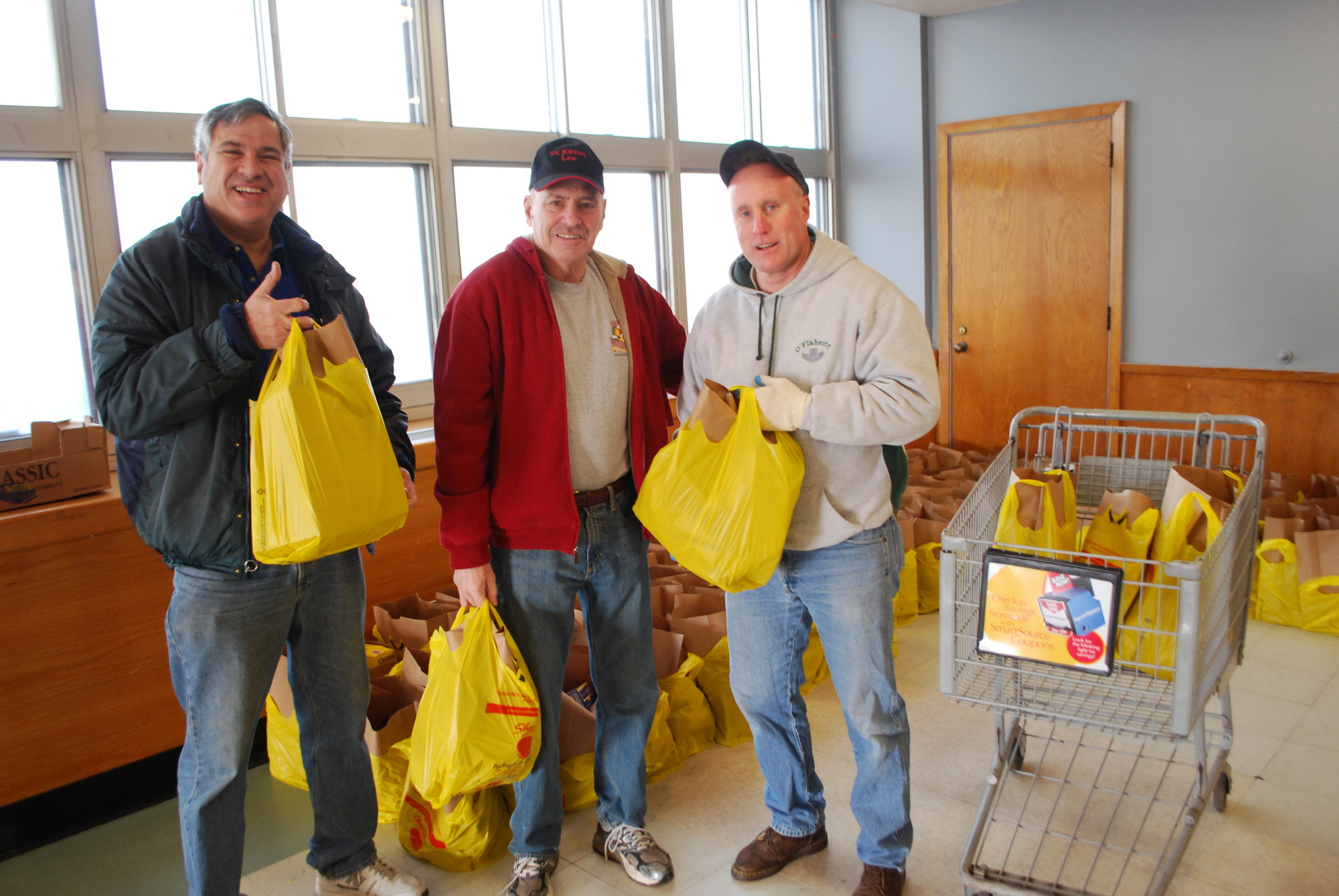Dr. Steven Perrick, Alan Hodish  — the basket initiative chairmen — and Kiwanis President Brian O'Flaherty loaded up the packages on Saturday morning.