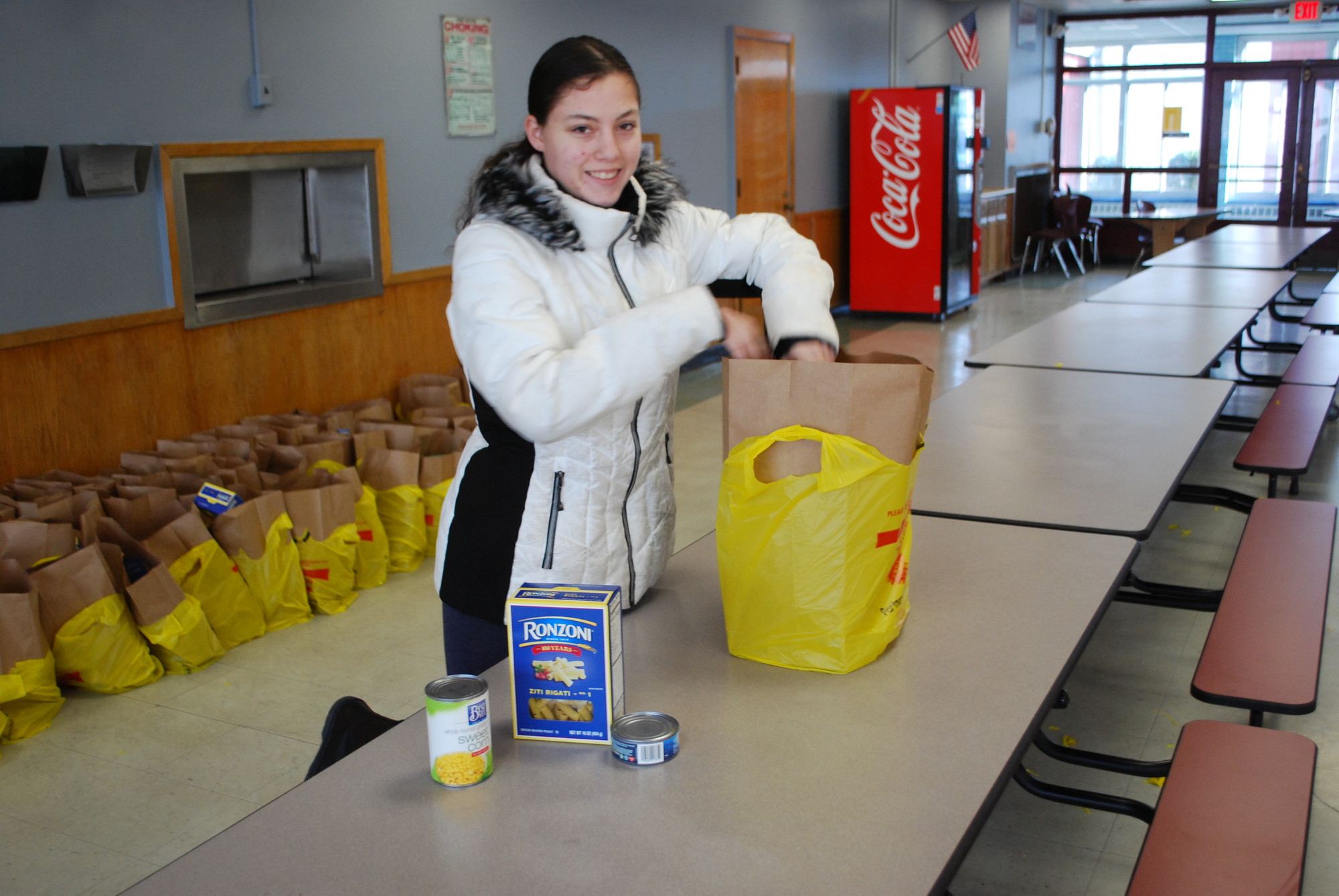 Melissa Kamper, 16, prepared a package for a family.
