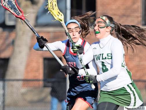 Lynbrook's Gina Giovinco, right, worked against South Side's Katherine Parker during a Conference IV overtime battle on April 5.