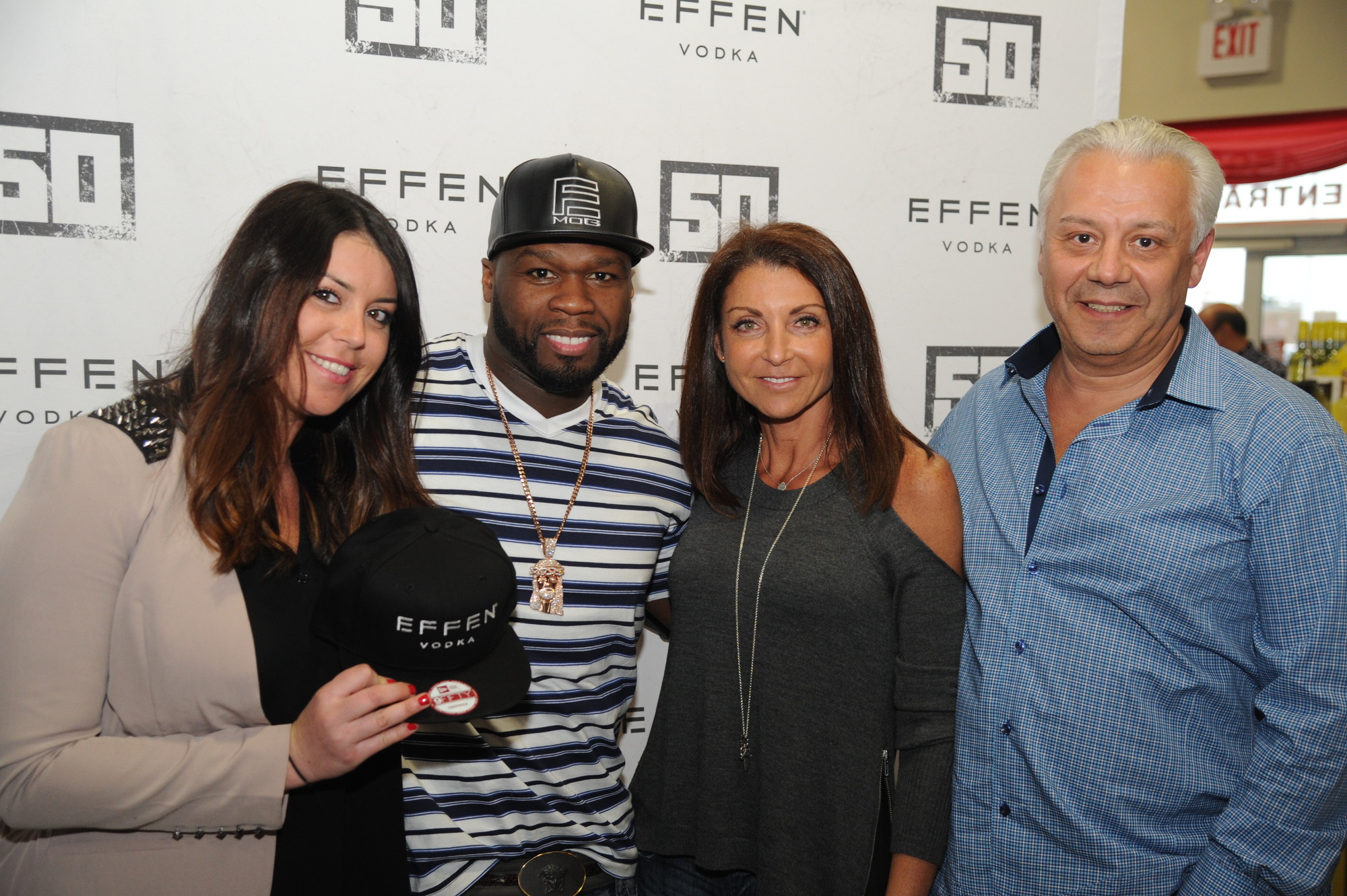 50 Cent posed with Wine & Liquor store owners Lauren, left, Marina and Boris Kromas. (Donovan Berthoud/Herald)