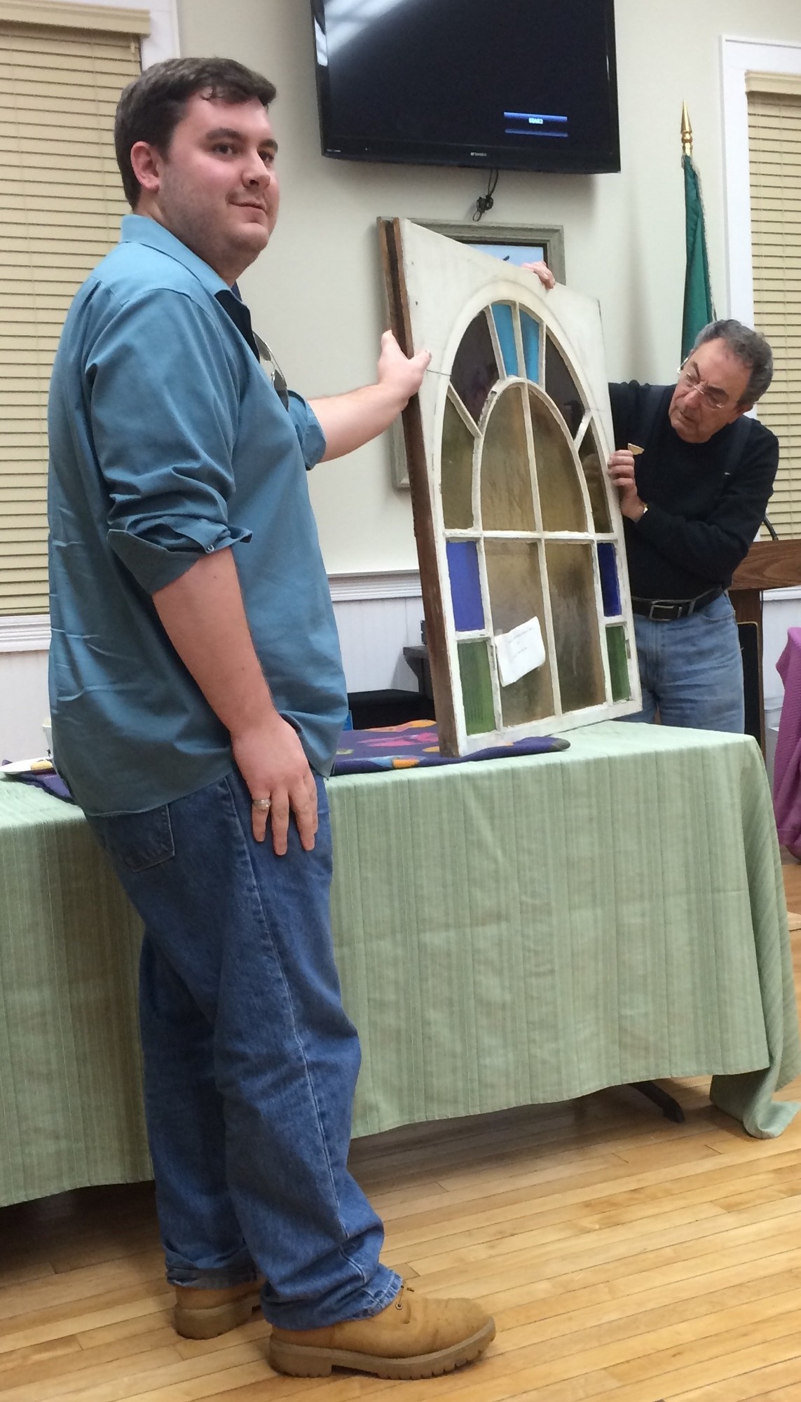 Historical Society board member Patrick Martz, left, showed Costello a stained glass window that was from the original Methodist Church building on Merrick Road.