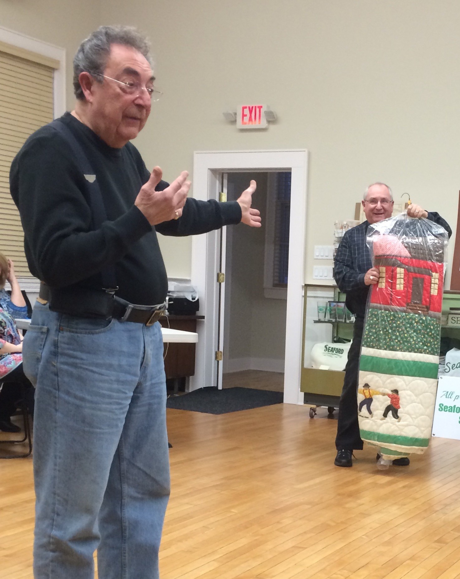 Steve Bongiovi, right, showed Eddie Costello a quilt from the 1960s that Costello valued at $12,000.