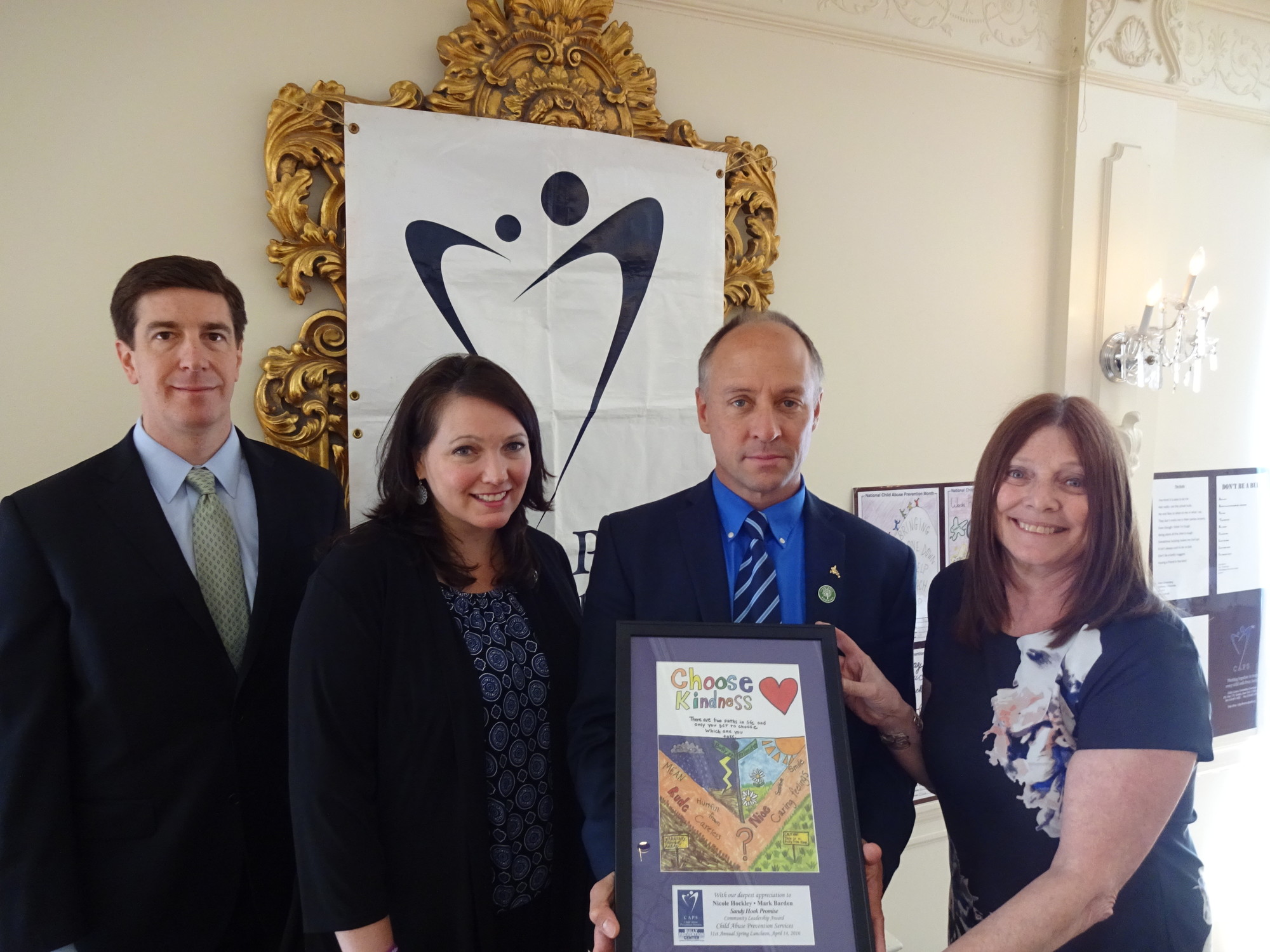 Child abuse prevention services Vice President Vincent Keaveny, far left, Nicole Hockley and Mark Barden — co-founders of Sandy Hook Promise — and CAPS Executive Director Alane Fagin met last week after the local group 
presented the Connecticut parents with an award.