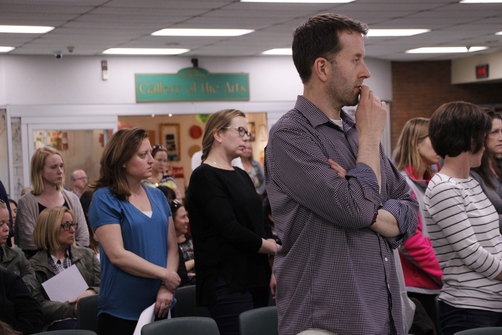 Dozens of residents stood to show their support while Sean Murray presented the Board of Education with a petition urging trustees to revise the high school’s renovation plans.