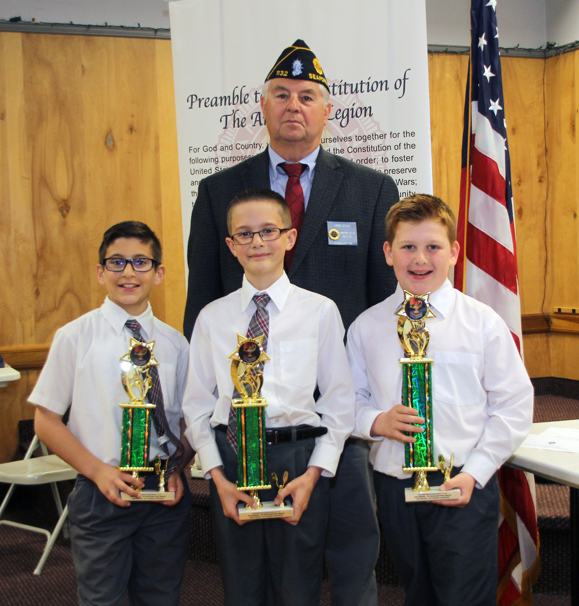 Legionnaire March Caleco with the St. William the Abbot School fourth-grade winners of the Seaford American Legion Essay Contest 1st Place Nolan Papagno, 2nd Place Ryan Miller and 3rd Place Salvatore Caputo
