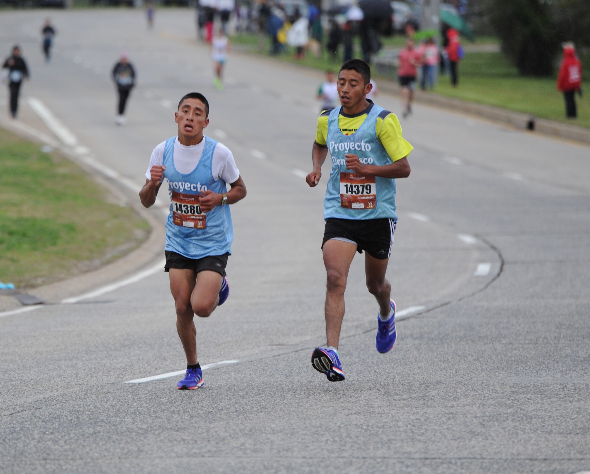 Brothers Wilson, left, and Erick Chavez Chox raced toward the finish line during last Sunday’s half-marathon. Erick won the race, and Wilson finished second.