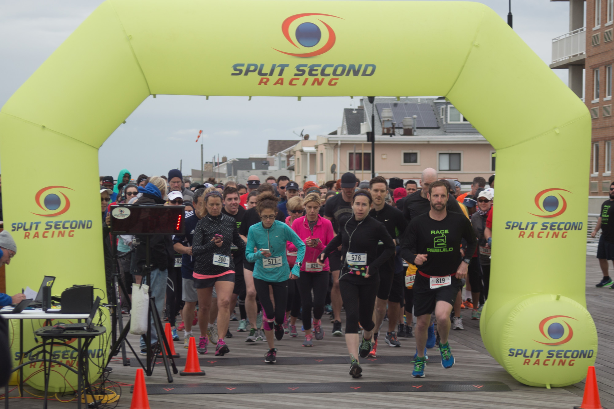 Runners began the Race2Rebuild event last Saturday morning on the boardwalk, as the event featured a 5K run and walk, a 2-mile "hardcore" beach run with obstacles and a post-race effort by volunteers to rebuild homes destroyed in Hurricane Sandy.