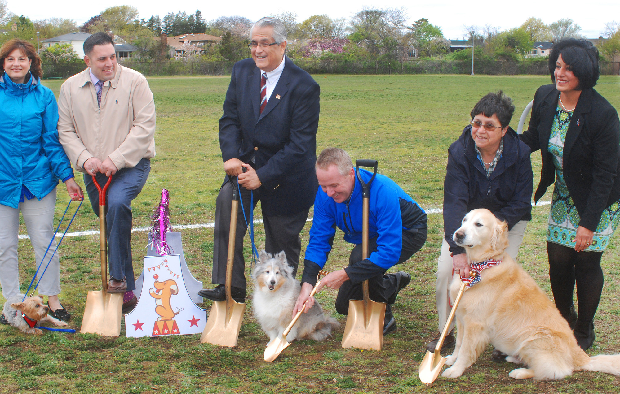 Oliver, from left, Sparkles and Cooper, the dogs, helped break ground on May 5 on a new 14,024-square-foot dog park at Newbridge Road Park in Bellmore, with assistance from Town of Hempstead officials and employees.