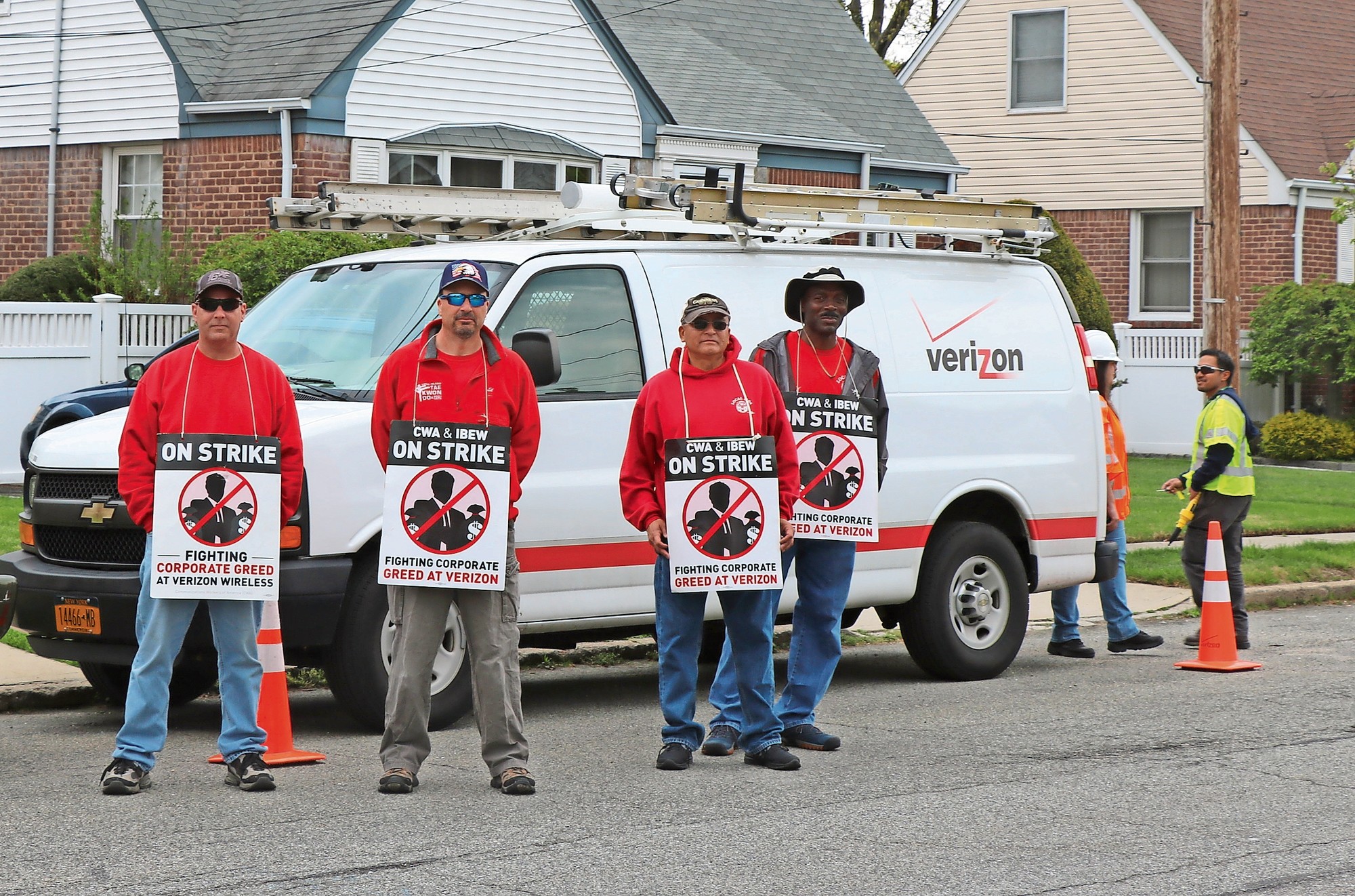 Striking Verizon workers were in Malverne recently, picketing in front of a home being serviced by non-union workers on Morris Avenue West. From left were Ken Lerner of Coram, Edward LaChappelle of West Hempstead, Carlos Oscolava of Massapequa and a worker who declined to be identified.