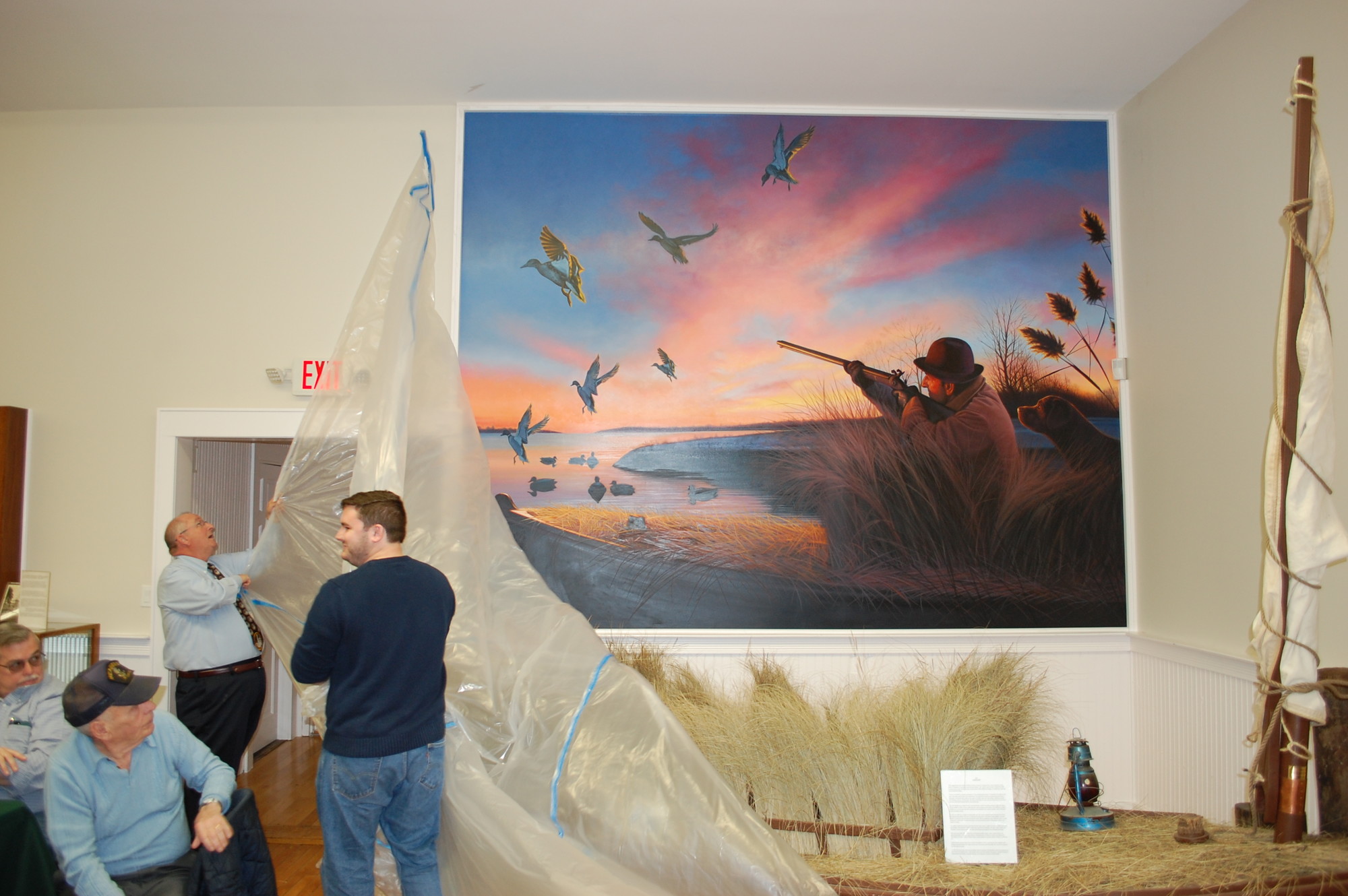 Historical Society officers Steve Bongiovi, left, and Patrick Martz unveiled the mural that depicts duck hunting in Seaford in the early 1900s.