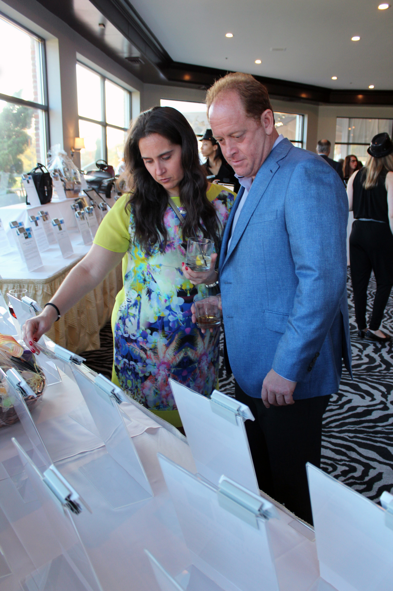 Melissa Gold and Greg Lobel viewed the items up for auction at the SIBSPlace event.